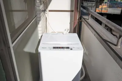 a white refrigerator with a box on top of it at Fuufu House Tokyo Ikebukuro in Tokyo