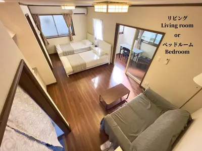 a living room with a bed and a couch at 7\u6642IN19\u6642OUT # \u897f\u6b66\u65b0\u5bbf\u99c5\u96fb\u8eca11\u5206 # \u30c6\u30e9\u30b9 # \u30d9\u30c3\u30c8\u53ef # \u65b0\u898f # \u6700\u59274\u540d # \u5c02\u7528\u30d0\u30b9\u30ad\u30c3\u30c1\u30f3 # 7 00 IN19 00 OUT # 11 min train to Seibu Shinjuku # Terrace # Bed available # Newly renovated # Max 4 guests # Private bath kitchen in Tokyo