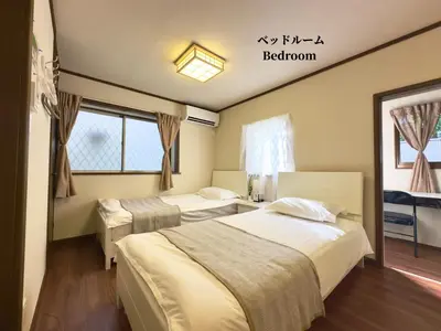 a bedroom with two beds and a window at 7\u6642IN19\u6642OUT # \u897f\u6b66\u65b0\u5bbf\u99c5\u96fb\u8eca11\u5206 # \u30c6\u30e9\u30b9 # \u30d9\u30c3\u30c8\u53ef # \u65b0\u898f # \u6700\u59274\u540d # \u5c02\u7528\u30d0\u30b9\u30ad\u30c3\u30c1\u30f3 # 7 00 IN19 00 OUT # 11 min train to Seibu Shinjuku # Terrace # Bed available # Newly renovated # Max 4 guests # Private bath kitchen in Tokyo