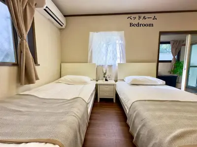 two beds sitting next to each other in a room at 7\u6642IN19\u6642OUT # \u897f\u6b66\u65b0\u5bbf\u99c5\u96fb\u8eca11\u5206 # \u30c6\u30e9\u30b9 # \u30d9\u30c3\u30c8\u53ef # \u65b0\u898f # \u6700\u59274\u540d # \u5c02\u7528\u30d0\u30b9\u30ad\u30c3\u30c1\u30f3 # 7 00 IN19 00 OUT # 11 min train to Seibu Shinjuku # Terrace # Bed available # Newly renovated # Max 4 guests # Private bath kitchen in Tokyo