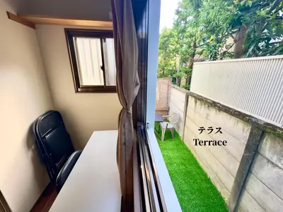 a room with a window with a table and a grass yard at 7\u6642IN19\u6642OUT # \u897f\u6b66\u65b0\u5bbf\u99c5\u96fb\u8eca11\u5206 # \u30c6\u30e9\u30b9 # \u30d9\u30c3\u30c8\u53ef # \u65b0\u898f # \u6700\u59274\u540d # \u5c02\u7528\u30d0\u30b9\u30ad\u30c3\u30c1\u30f3 # 7 00 IN19 00 OUT # 11 min train to Seibu Shinjuku # Terrace # Bed available # Newly renovated # Max 4 guests # Private bath kitchen in Tokyo