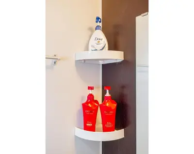 a shelf with ketchup and ketchup bottles on it at KYARA Hotel 402 in Tokyo