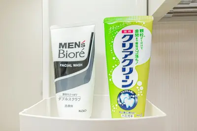 two toothbrushes and a tube of toothpaste in a refrigerator at KYARA Hotel 402 in Tokyo