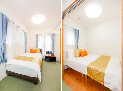 two beds in a room with two windows at KYARA Hotel 402 in Tokyo