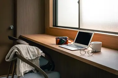 a laptop computer sitting on a desk next to a window at YOYOGI PARK HOTEL in Tokyo