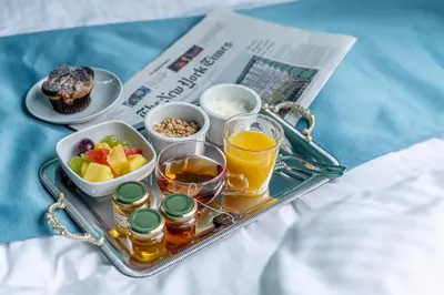 a tray of food with fruit and drinks and a newspaper at YOYOGI PARK HOTEL in Tokyo