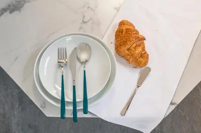 a plate with fork and knife and a piece of bread at YOYOGI PARK HOTEL in Tokyo