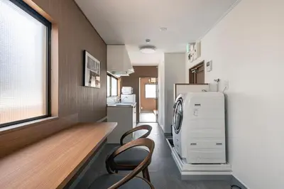 a kitchen with a refrigerator and two chairs in it at YOYOGI PARK HOTEL in Tokyo