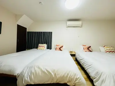 two beds in a room with white sheets at STS-Senzoku House-TT0187 in Tokyo