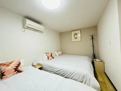 two beds in a room with white walls at STS-Senzoku House-TT0187 in Tokyo