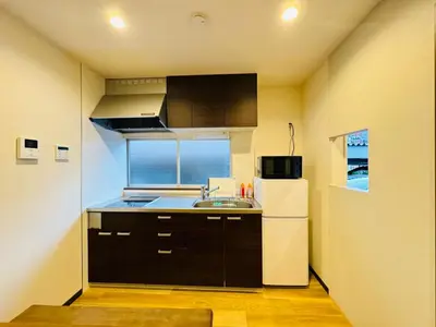 a small kitchen with a sink and a refrigerator at STS-Senzoku House-TT0187 in Tokyo