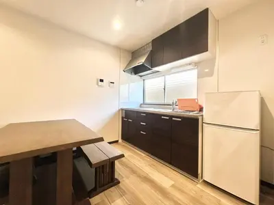 a small kitchen with a table and a refrigerator at STS-Senzoku House-TT0187 in Tokyo