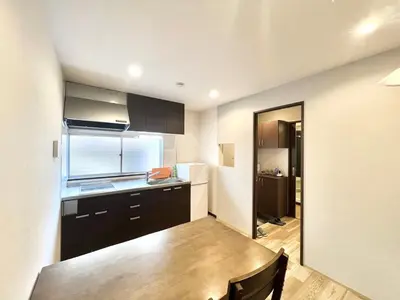 a kitchen with a table and a refrigerator at STS-Senzoku House-TT0187 in Tokyo