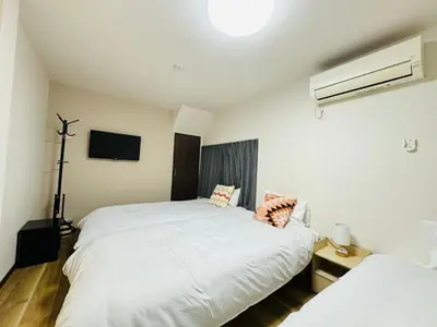 a bedroom with two white beds and a tv at STS-Senzoku House-TT0187 in Tokyo