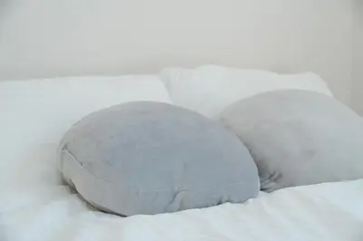 two pillows sitting on top of a white bed at CON-TWO 201 in Tokyo