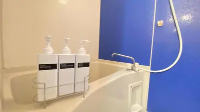 a bath tub with four bottles on the side of it at CON-TWO 201 in Tokyo