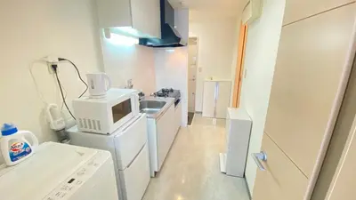 a kitchen with a microwave and a sink in it at CON-TWO 201 in Tokyo