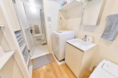 a small bathroom with a sink and a refrigerator at FARE Akihabara - Stylish Studio 8min from Station 102 in Tokyo