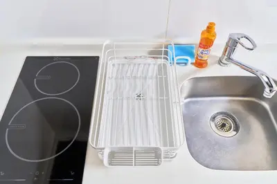 a kitchen sink with a whisk sitting next to it at FARE Akihabara - Stylish Studio 8min from Station 102 in Tokyo