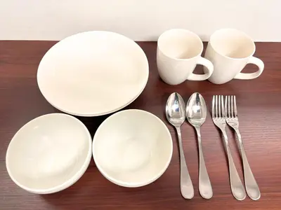 a table with white plates and forks and spoons at FARE Akihabara - Stylish Studio 8min from Station 102 in Tokyo