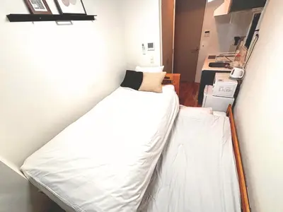 a bedroom with two beds in a room at FARE Akihabara - Stylish Studio 8min from Station 102 in Tokyo