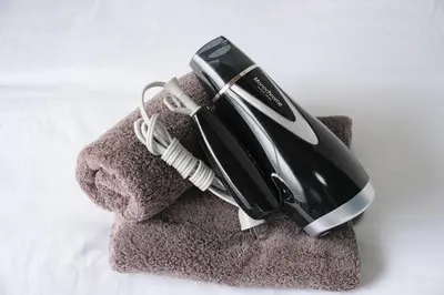 a hair dryer sitting on top of a towel at Push house \u6d66\u5b89 in Tokyo