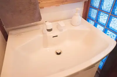 a bathroom sink with two bottles on top of it at Push house \u6d66\u5b89 in Tokyo