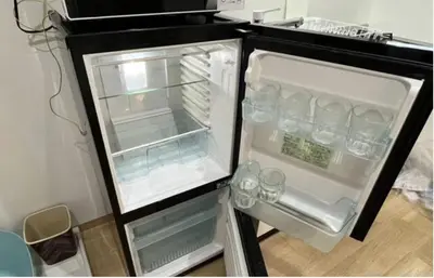 an empty refrigerator with its door open in a kitchen at Tokyo Stay \u821e in Tokyo