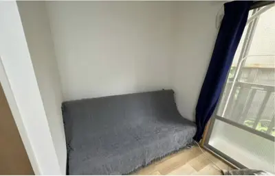 a gray couch in a room with a window at Tokyo Stay \u821e in Tokyo