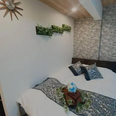 a bedroom with a bed and a cross on the wall at 54, Tateishi, Entire house for rent, \u7acb\u77f3 in Tokyo