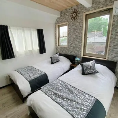 two beds in a room with two windows at 54, Tateishi, Entire house for rent, \u7acb\u77f3 in Tokyo