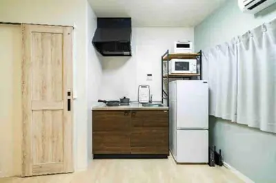 a kitchen with a white refrigerator and a door at 55, Kameido-Suijin, Entire house for rent, \u4e80\u6238\u6c34\u795e in Tokyo