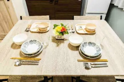 a table with plates and utensils on it at 55, Kameido-Suijin, Entire house for rent, \u4e80\u6238\u6c34\u795e in Tokyo