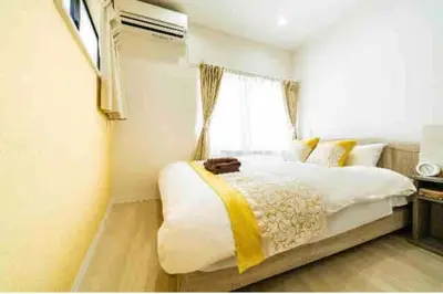 a bedroom with a large bed with a window at 55, Kameido-Suijin, Entire house for rent, \u4e80\u6238\u6c34\u795e in Tokyo