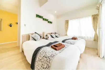 two beds in a room with white walls at 55, Kameido-Suijin, Entire house for rent, \u4e80\u6238\u6c34\u795e in Tokyo