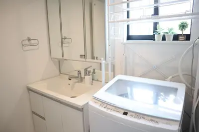 a white bathroom with a sink and a window at L\uff06L\uff08Love\uff06Life\uff09 in Tokyo