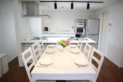 a white kitchen with a white table and chairs at L\uff06L\uff08Love\uff06Life\uff09 in Tokyo