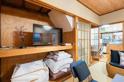 a living room with a tv on a wall at Max12PPL!7m walk from station!Japan style house! in Tokyo