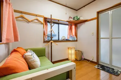 a living room with a green couch and a window at Max12PPL!7m walk from station!Japan style house! in Tokyo