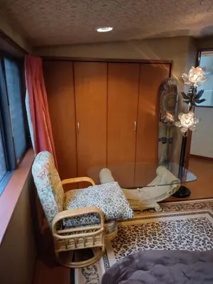 a living room with a chair and a cabinet at Stage YOU in Tokyo