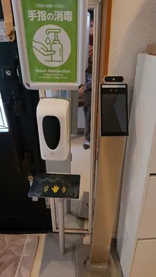 a bathroom with a urinal and a sign in a room at Stage YOU in Tokyo