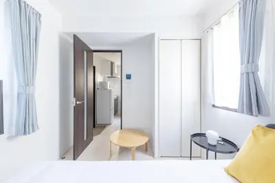 a bedroom with a bed and a table and a chair at 67 Apt Koenji Tokyo in Tokyo