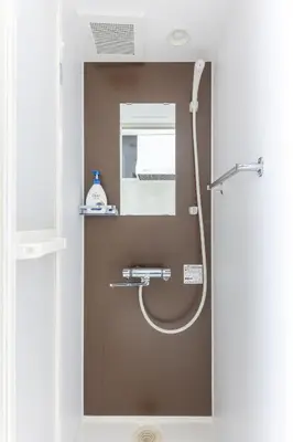 a bathroom with a shower with a hose at 67 Apt Koenji Tokyo in Tokyo
