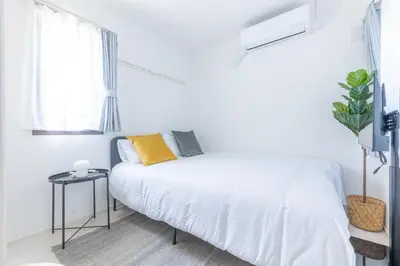 a white bedroom with a bed and a window at APB\u9ad8\u5186\u5bfa in Tokyo