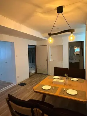 a living room with a table and chairs and a dining room at Kyo Sai \u6d45\u83492F\u6d45\u8349\u5bfa\u307e\u3067\u5f92\u6b65\u7d0410\u5206 in Tokyo