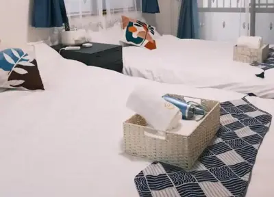 a basket on top of a white bed at TOKYOSTYLE in Tokyo