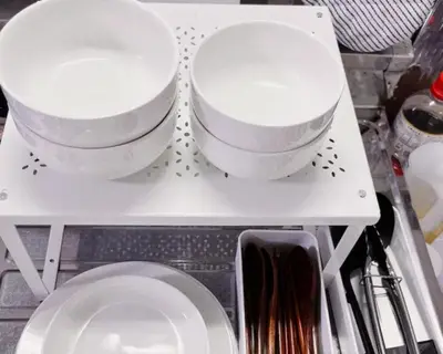 two bowls are sitting on a shelf with plates at TOKYOSTYLE in Tokyo