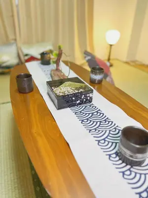 a wooden table with two cups on top of it at TOKYOSTYLE in Tokyo