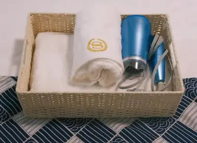 a basket filled with utensils on a bed at TOKYOSTYLE in Tokyo