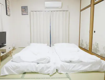 two white beds in a room with a window at TOKYOSTYLE in Tokyo